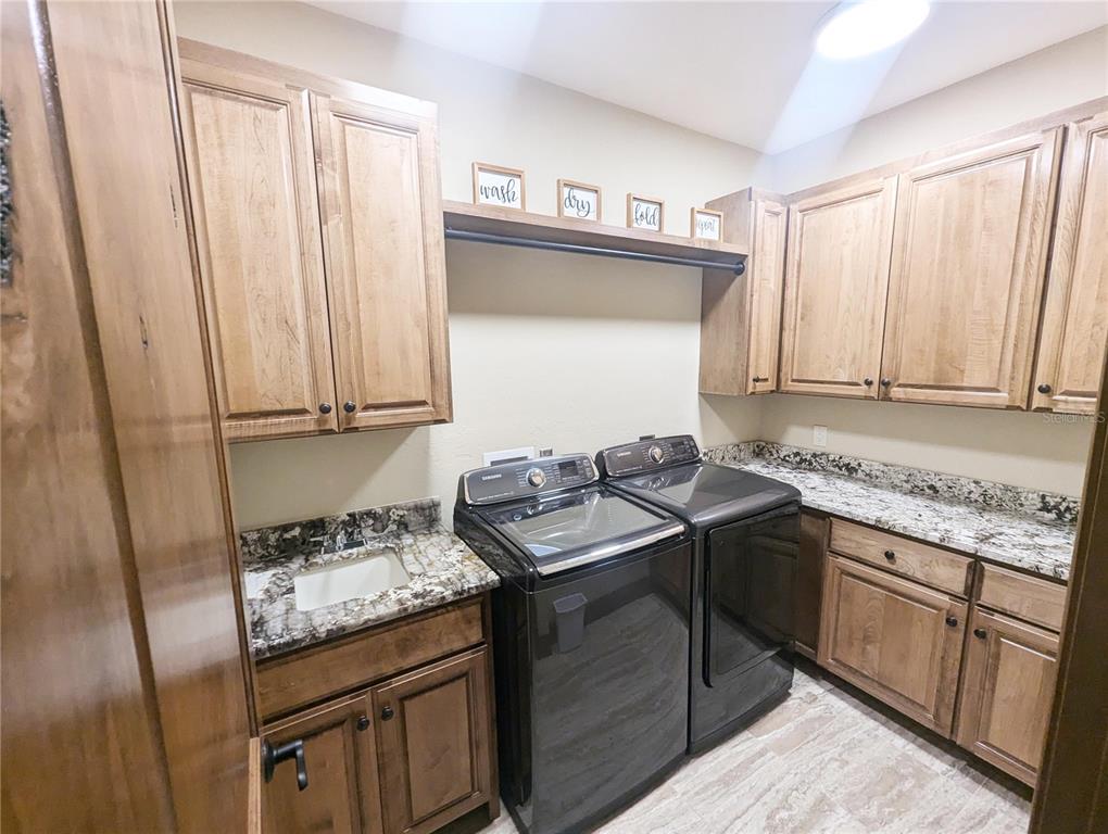 710 Albee Road West Nokomis, FL 34275 - Photo 29 of 30 a kitchen with stainless steel appliances granite countertop a sink stove and cabinets