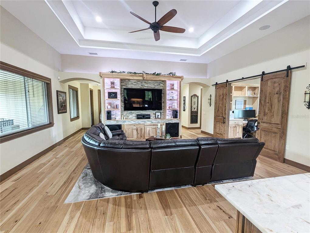 710 Albee Road West Nokomis, FL 34275 - Photo 10 of 30 a living room with couches and a flat screen tv with kitchen view