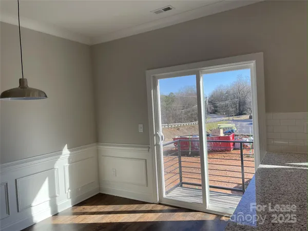 an empty room with a window and a ceiling fan