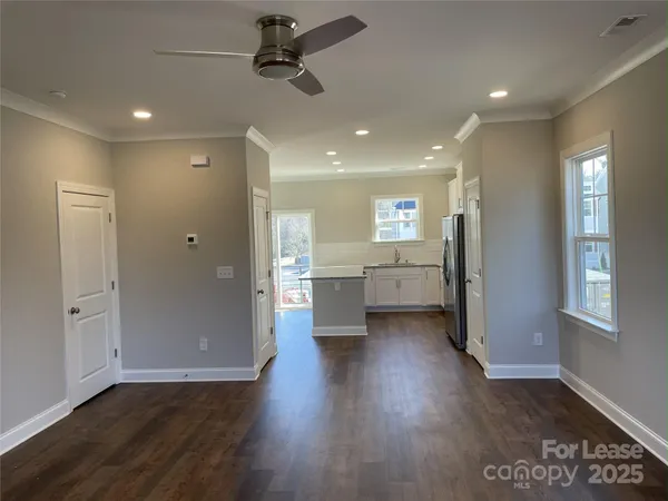 a view of a kitchen with a refrigerator and a stove top oven