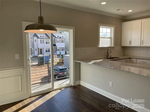 a kitchen with stainless steel appliances granite countertop a sink and a stove top oven