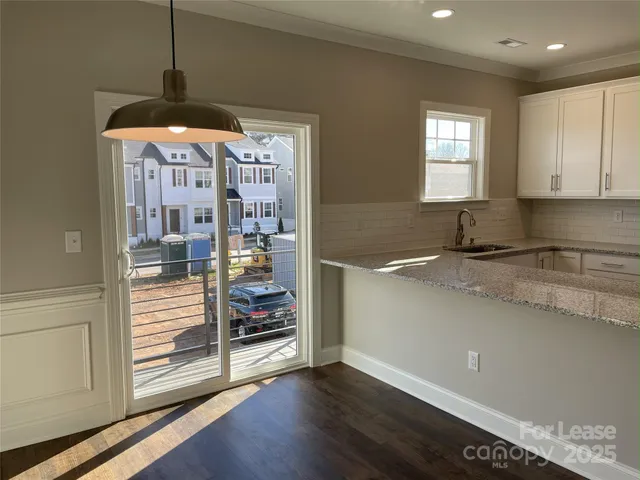 a kitchen with stainless steel appliances granite countertop a sink and a stove top oven