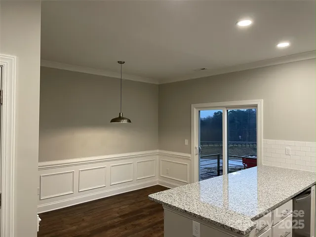 a view of a livingroom with wooden floor and cabinet