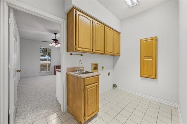 a utility room with cabinets washer and dryer