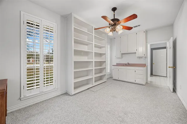 a view of a livingroom with a ceiling fan and a window