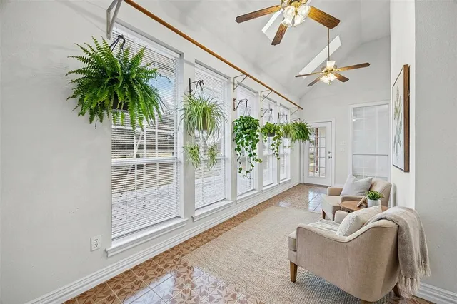 a living room with furniture and a potted plant