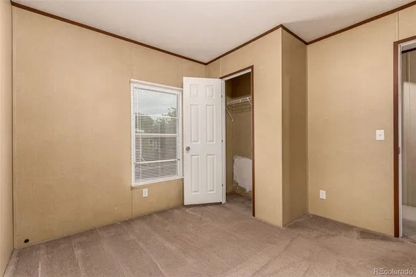 a view of a small space with wooden floor and a window