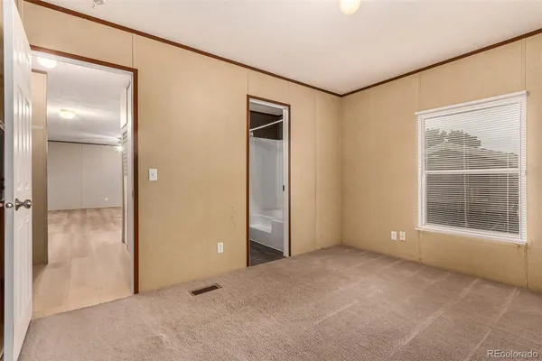 an empty room with windows and closet