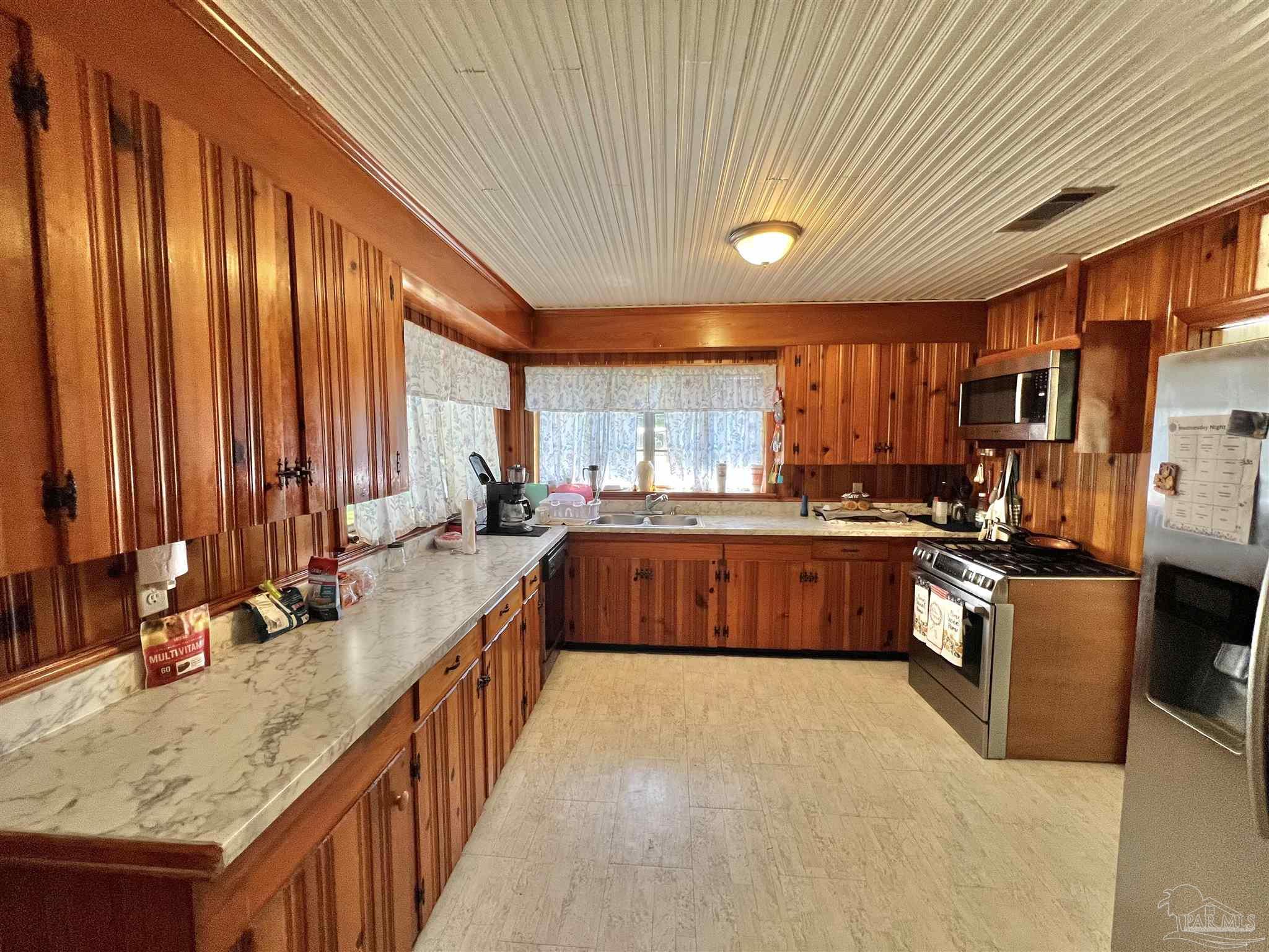 707 East Horner Street Atmore, AL 36502 - Photo 11 of 28 a large kitchen with stainless steel appliances kitchen island granite countertop a sink and cabinets