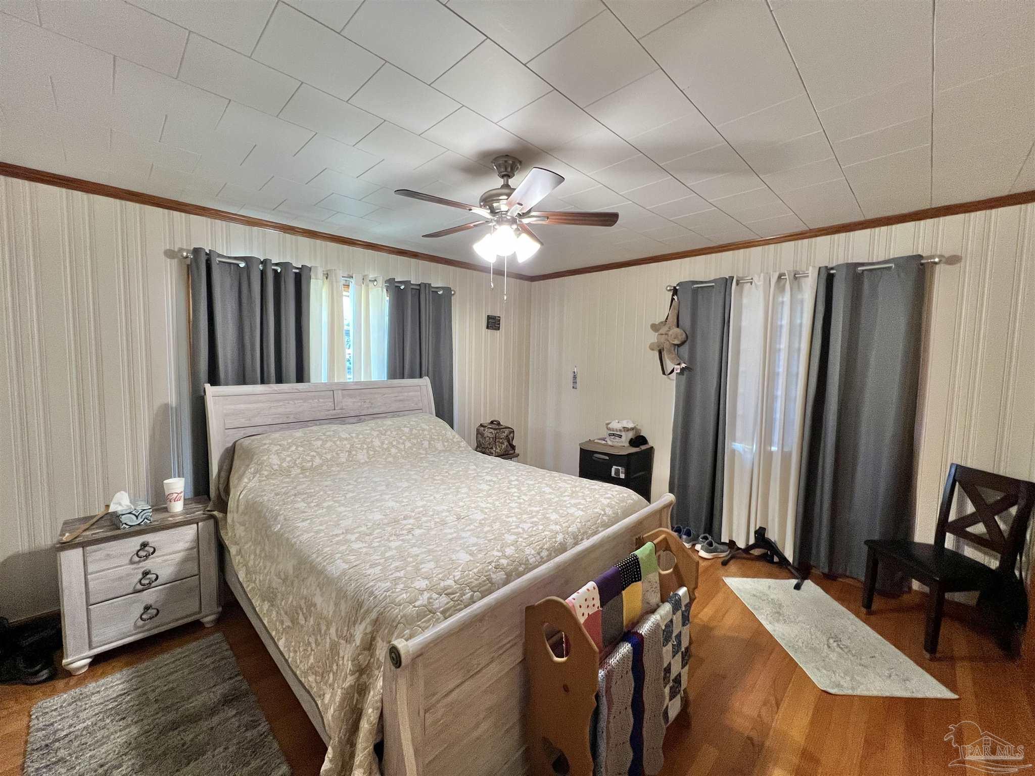 707 East Horner Street Atmore, AL 36502 - Photo 13 of 28 a spacious bedroom with a bed and a chandelier