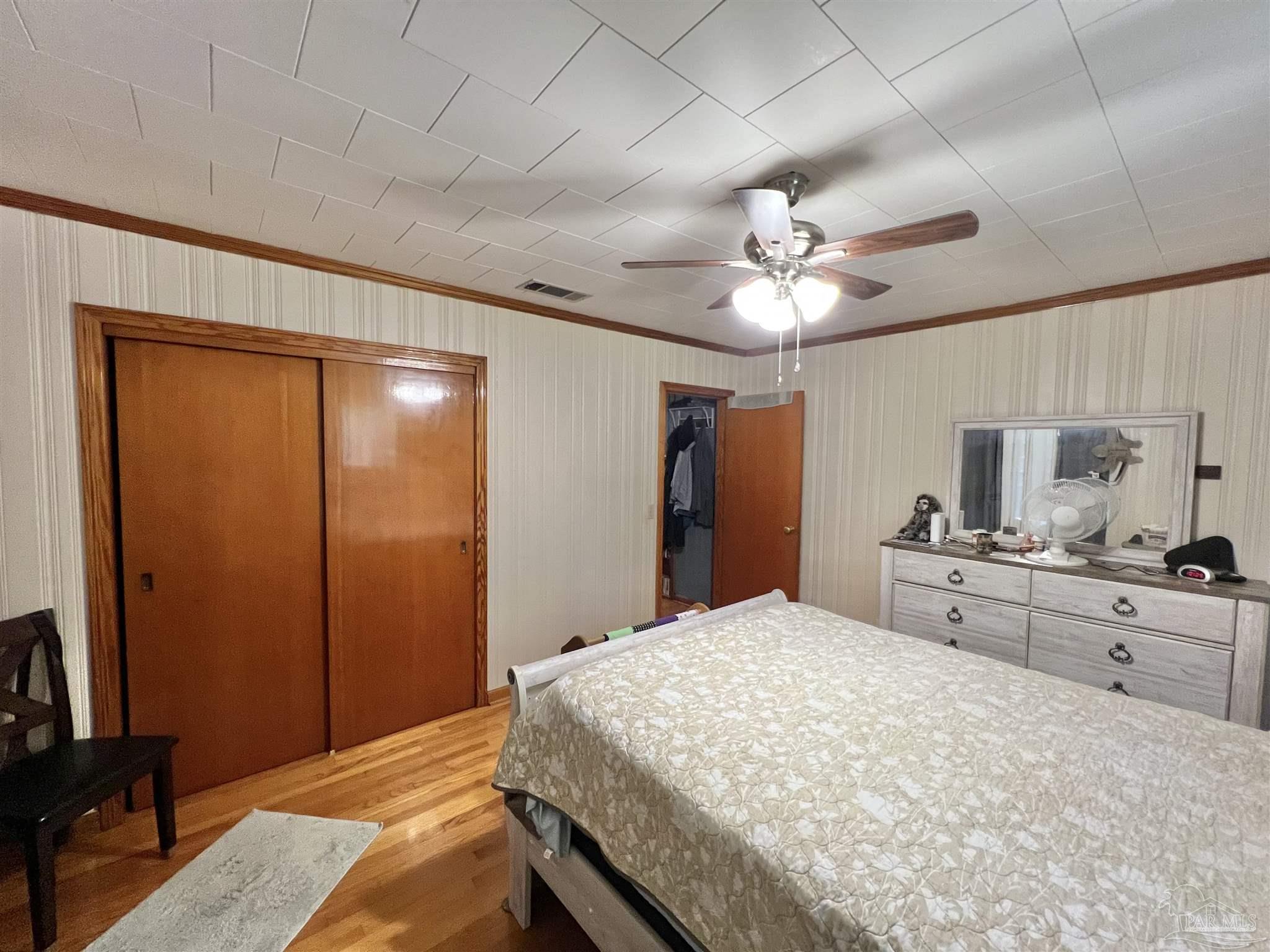 707 East Horner Street Atmore, AL 36502 - Photo 14 of 28 a large white bed in a hotel room and a chandelier