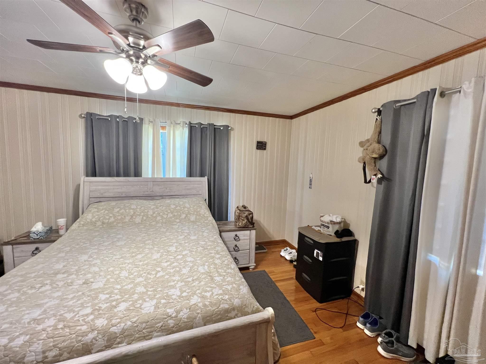 707 East Horner Street Atmore, AL 36502 - Photo 15 of 28 a very nice looking room with a large bed and a chandelier