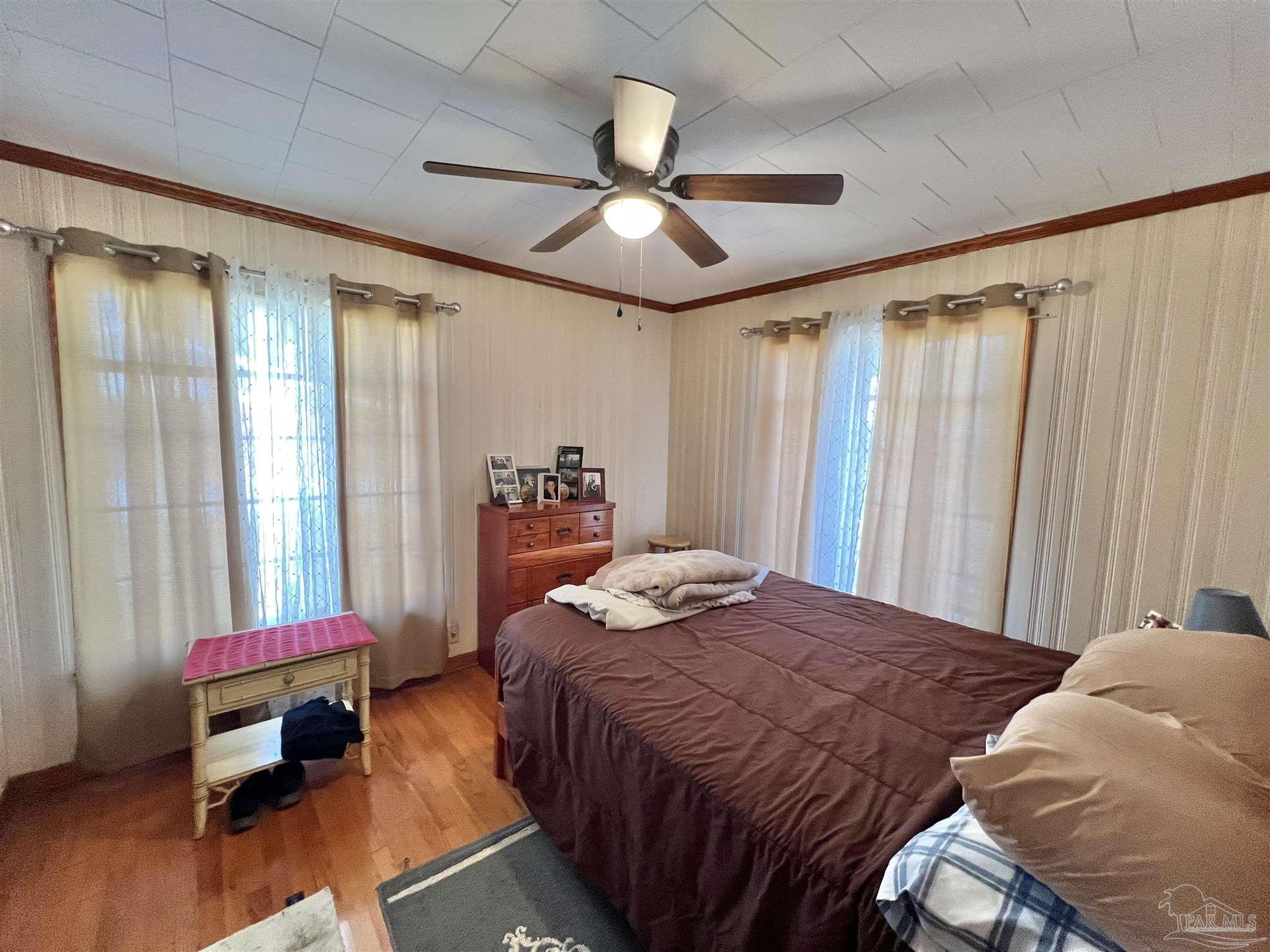 707 East Horner Street Atmore, AL 36502 - Photo 17 of 28 a bedroom with a bed and a chandelier
