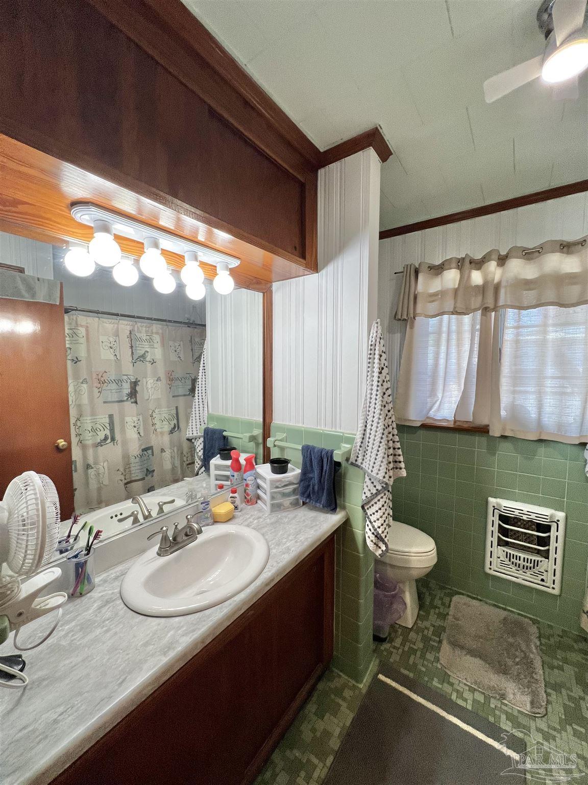 707 East Horner Street Atmore, AL 36502 - Photo 19 of 28 a bathroom with a sink vanity mirror and toilet
