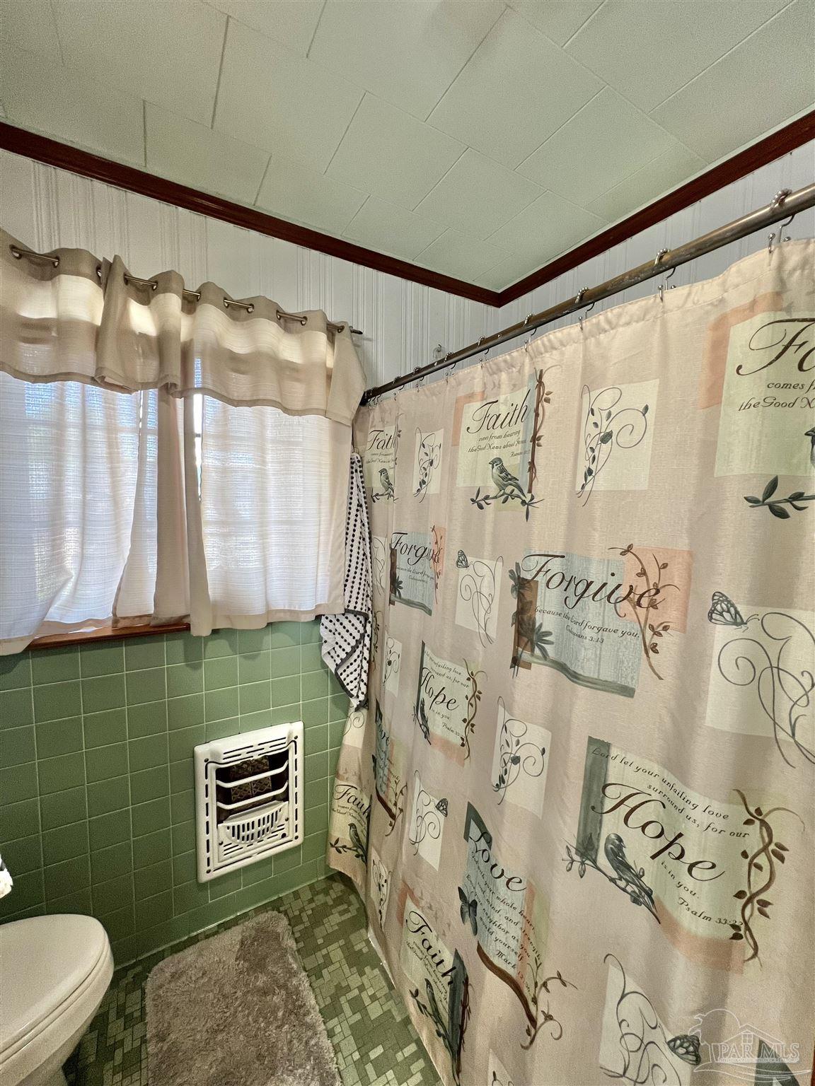 707 East Horner Street Atmore, AL 36502 - Photo 20 of 28 a bathroom with a toilet sink and shower curtain