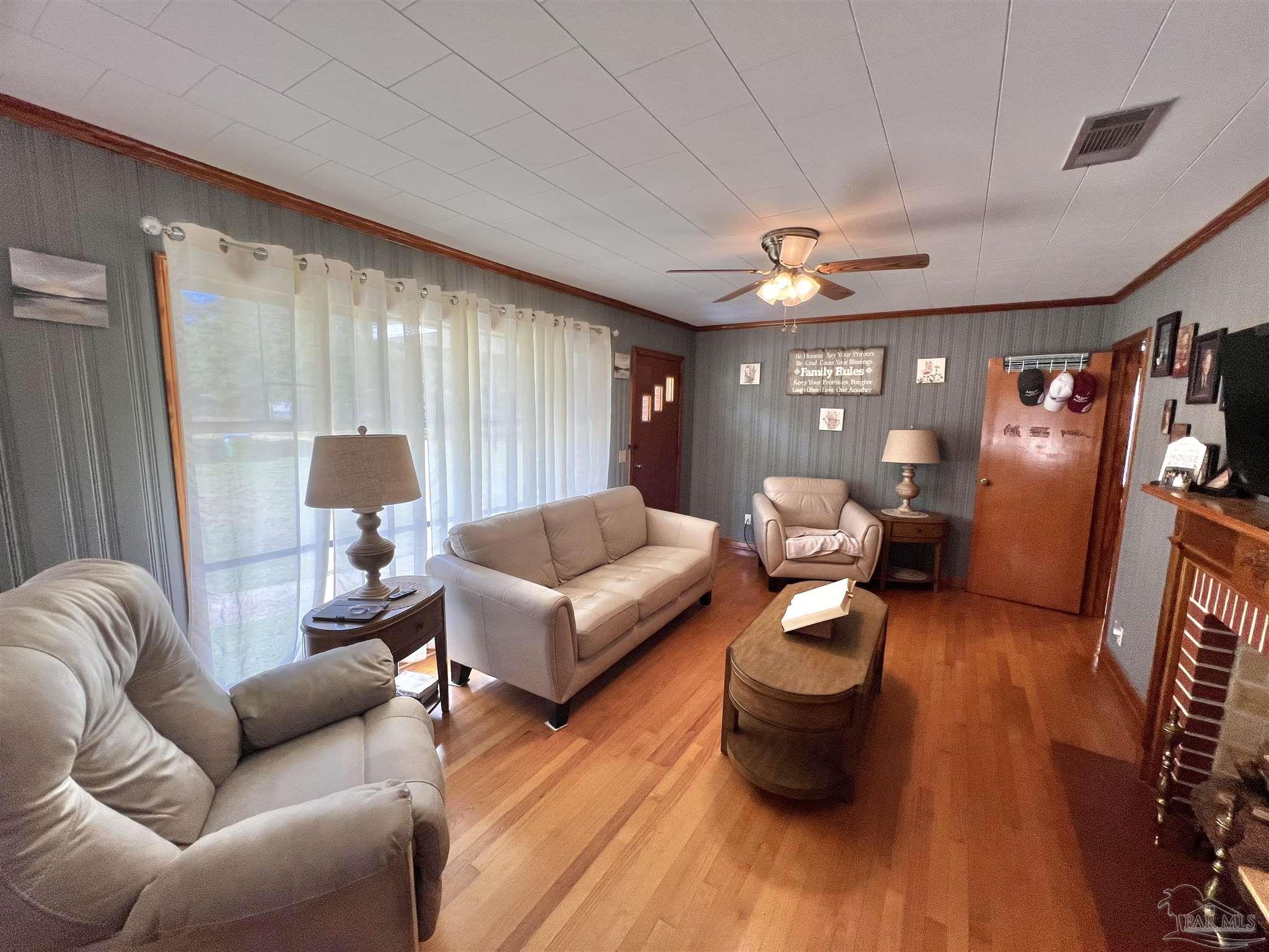 707 East Horner Street Atmore, AL 36502 - Photo 2 of 28 a living room with furniture and wooden floor