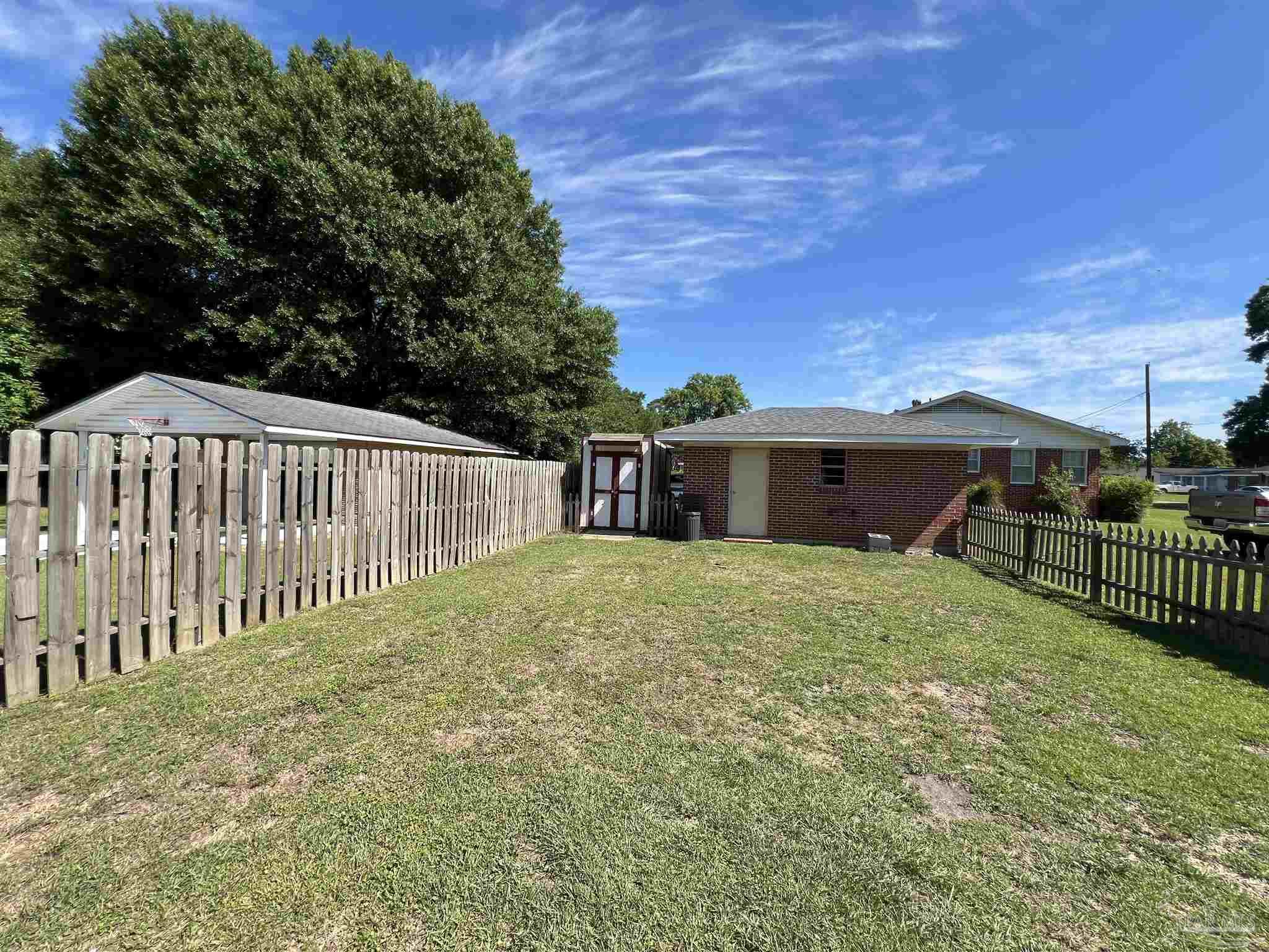 707 East Horner Street Atmore, AL 36502 - Photo 23 of 28 a view of a house with backyard and porch