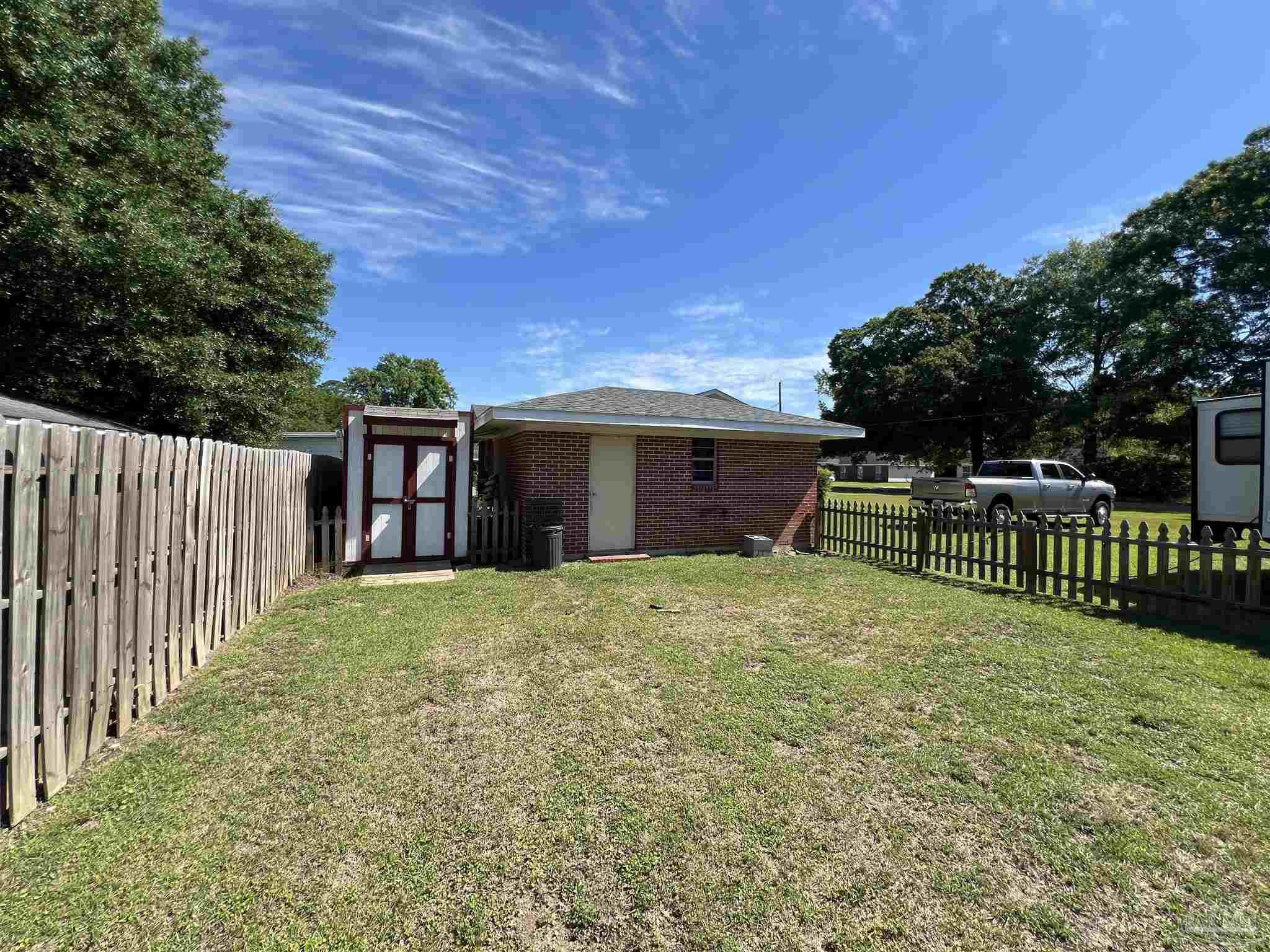 707 East Horner Street Atmore, AL 36502 - Photo 24 of 28 a fire hydrant in front of a yard with wooden fence