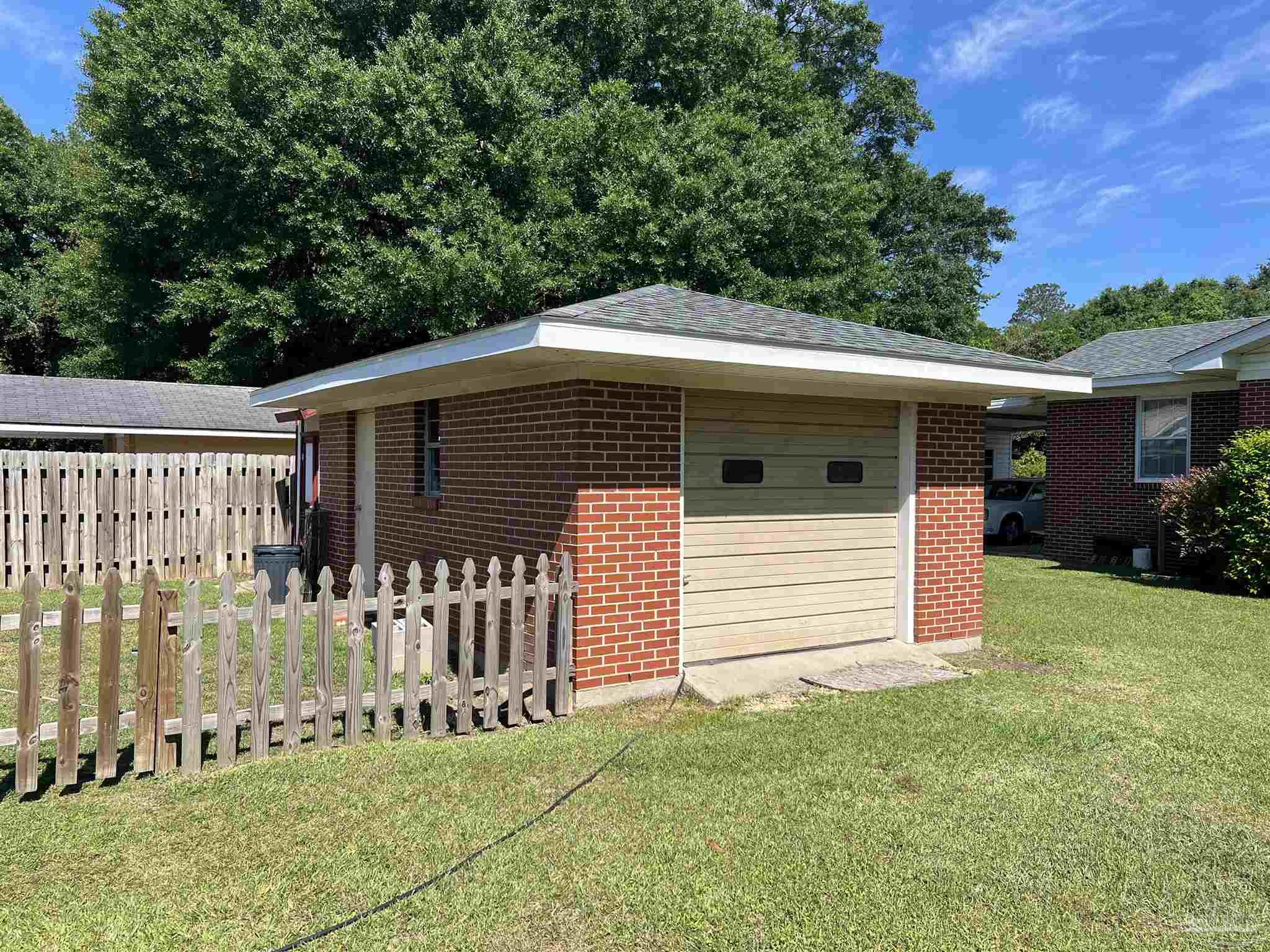 707 East Horner Street Atmore, AL 36502 - Photo 25 of 28 a front view of a house with a garden