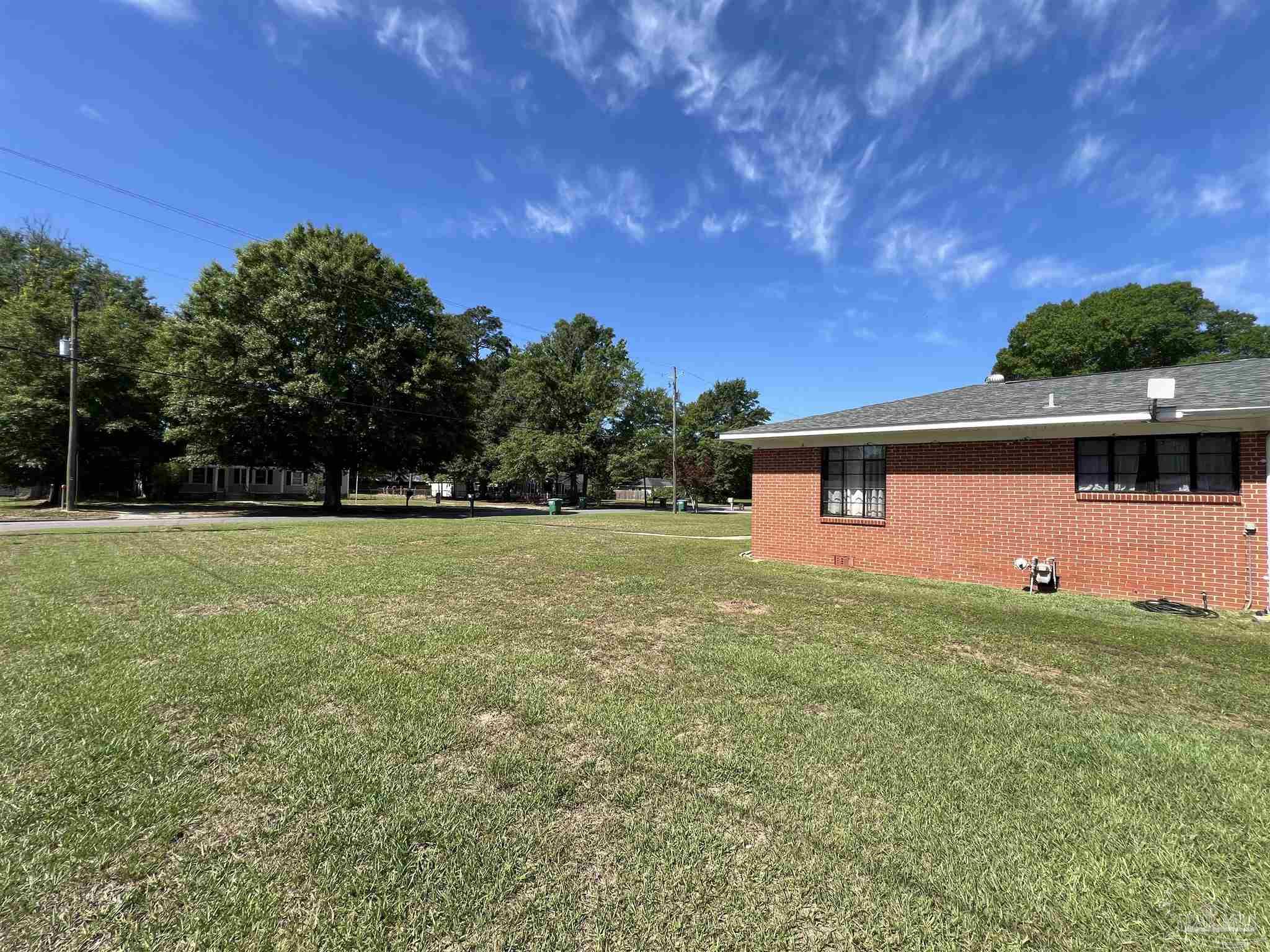 707 East Horner Street Atmore, AL 36502 - Photo 27 of 28 a backyard of a house with lots of green space