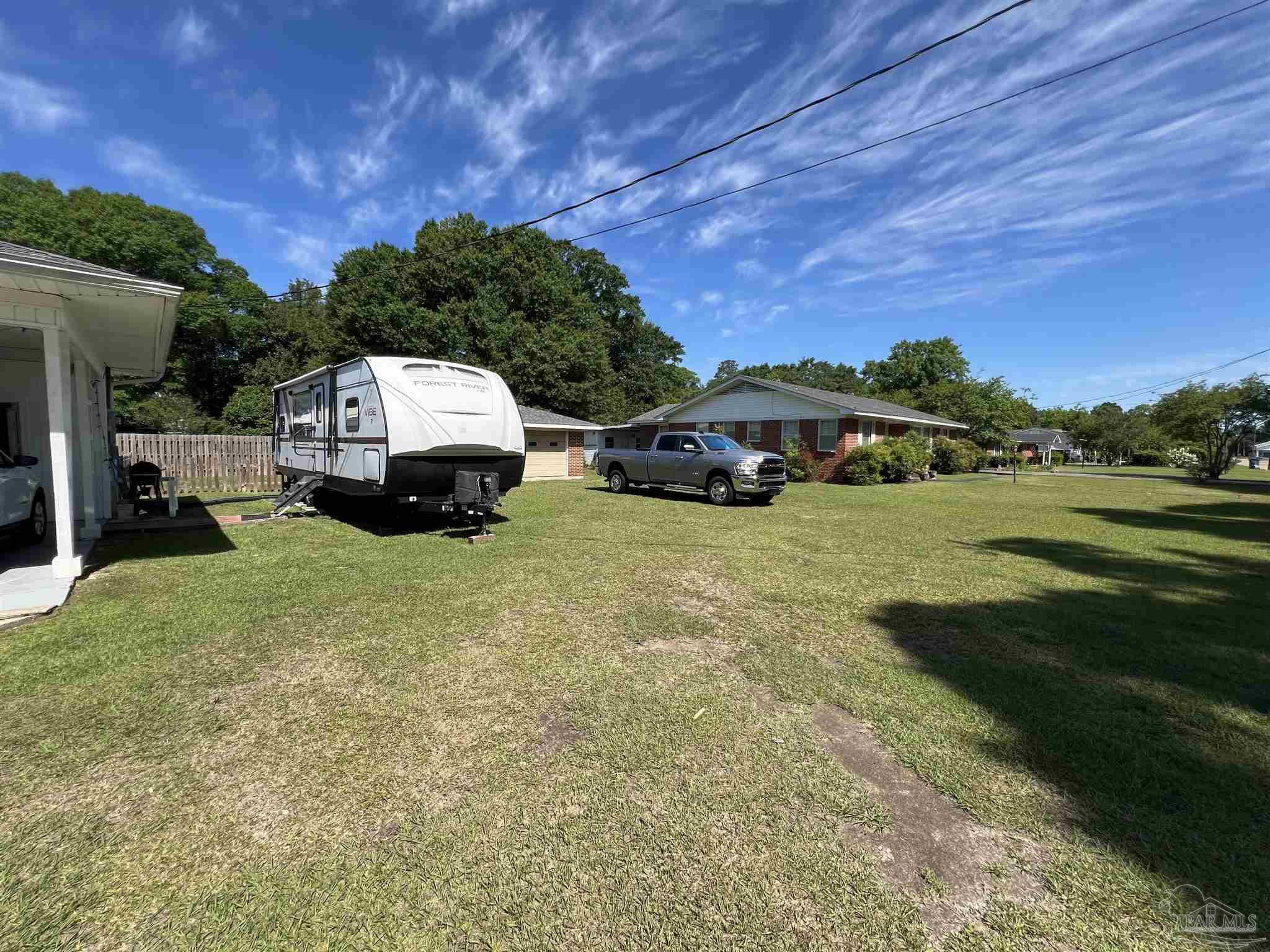 707 East Horner Street Atmore, AL 36502 - Photo 28 of 28 a view of car parked in front of house with a yard