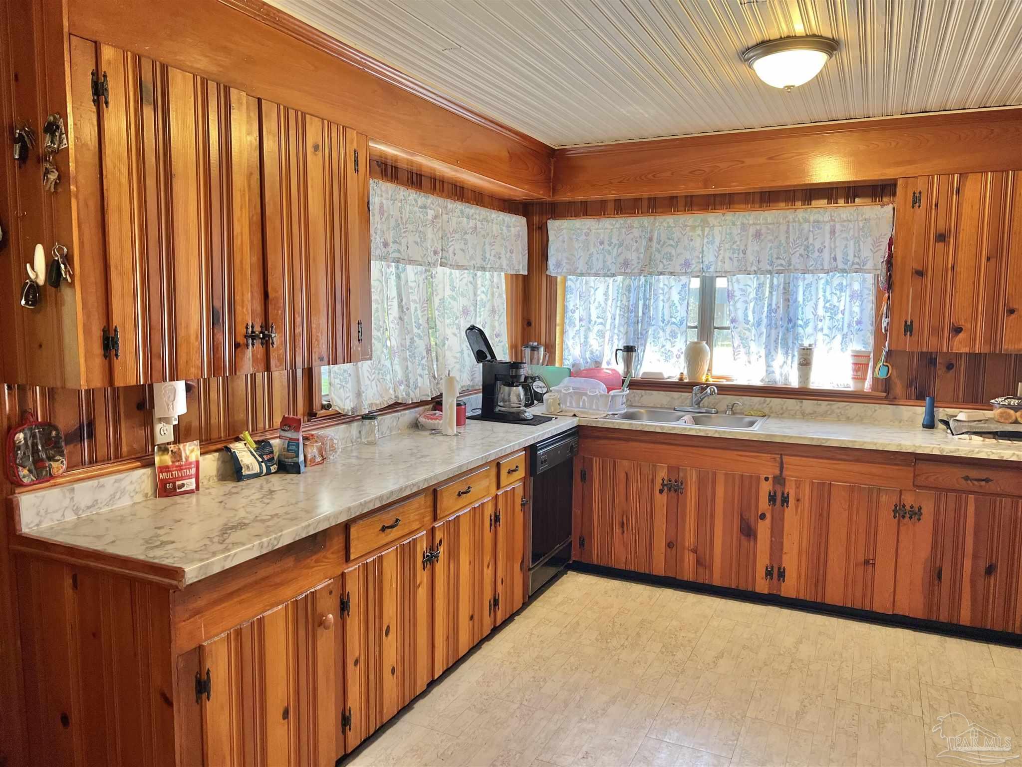 707 East Horner Street Atmore, AL 36502 - Photo 9 of 28 a kitchen with stainless steel appliances granite countertop a sink dishwasher cabinets and a large window