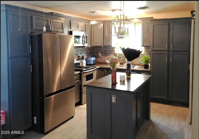 a kitchen with stainless steel appliances a refrigerator and a sink