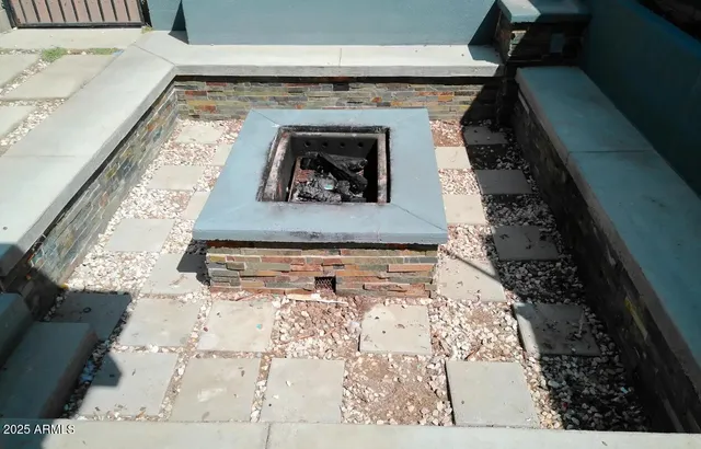 a view of living room with furniture and a fireplace