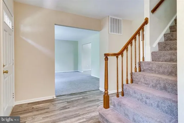 a view of entryway with wooden floor and stairs