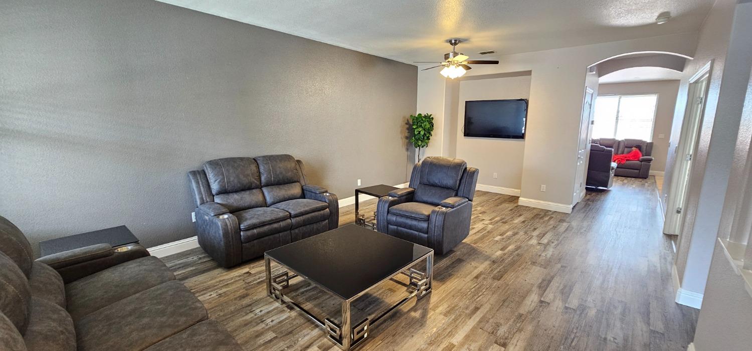 11724 Brook Valley Way Rancho Cordova, CA 95742 - Photo 16 of 32 a living room with furniture and a wooden floor