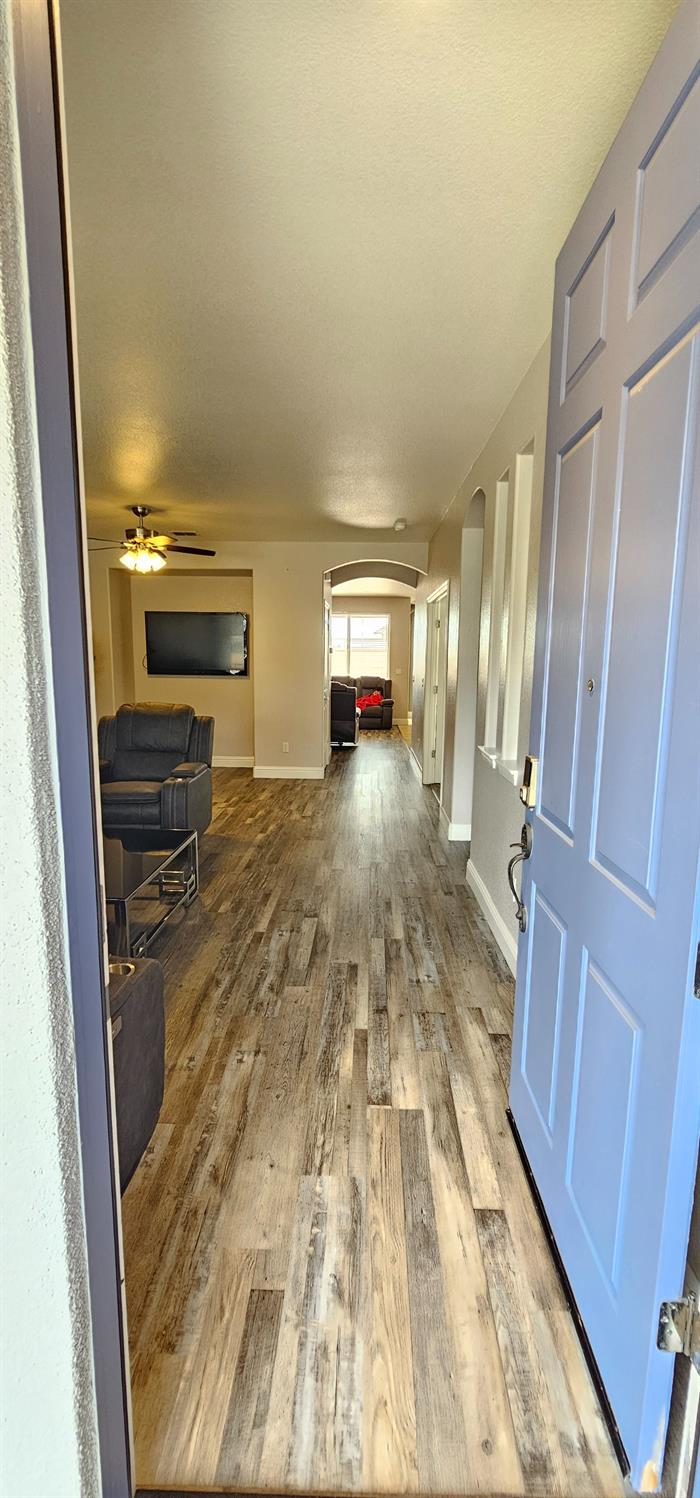 11724 Brook Valley Way Rancho Cordova, CA 95742 - Photo 18 of 32 a view of a hallway view with wooden floor and furniture
