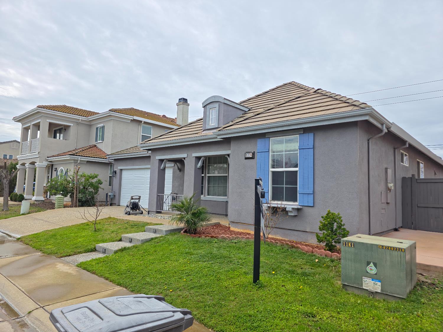 11724 Brook Valley Way Rancho Cordova, CA 95742 - Photo 2 of 32 a front view of a house with a garden and plants