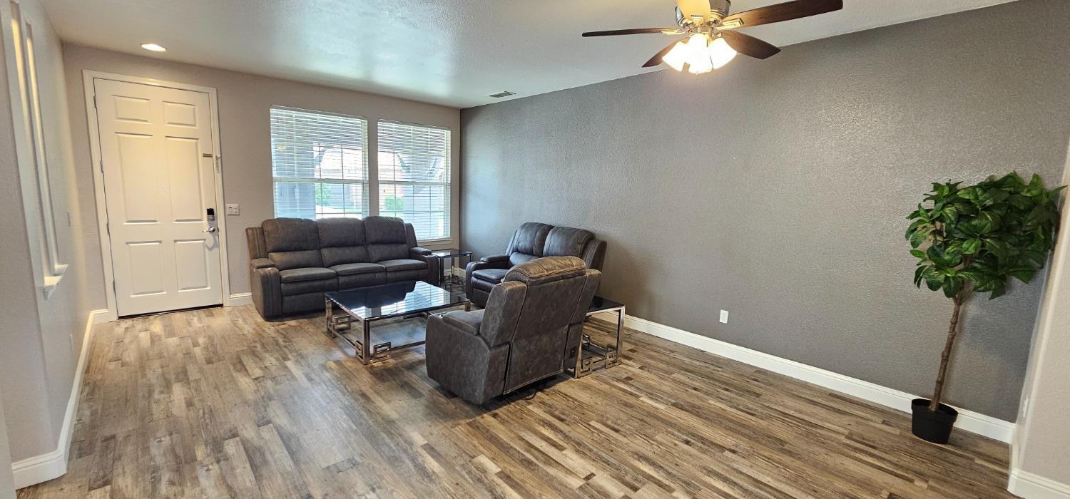 11724 Brook Valley Way Rancho Cordova, CA 95742 - Photo 21 of 32 a living room with furniture and a potted plant