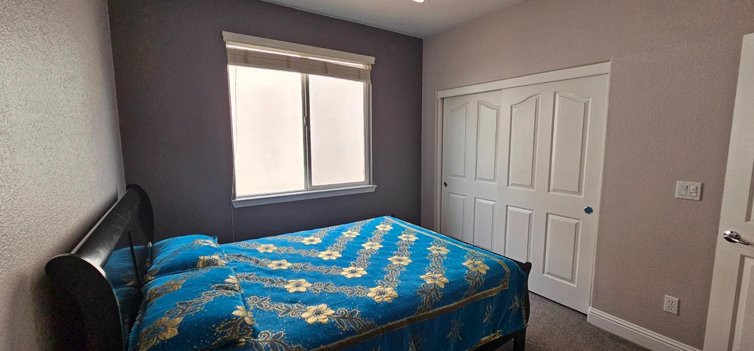 11724 Brook Valley Way Rancho Cordova, CA 95742 - Photo 22 of 32 a bedroom with a bed and a window