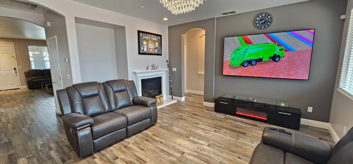 11724 Brook Valley Way Rancho Cordova, CA 95742 - Photo 25 of 32 a living room with furniture and a flat screen tv