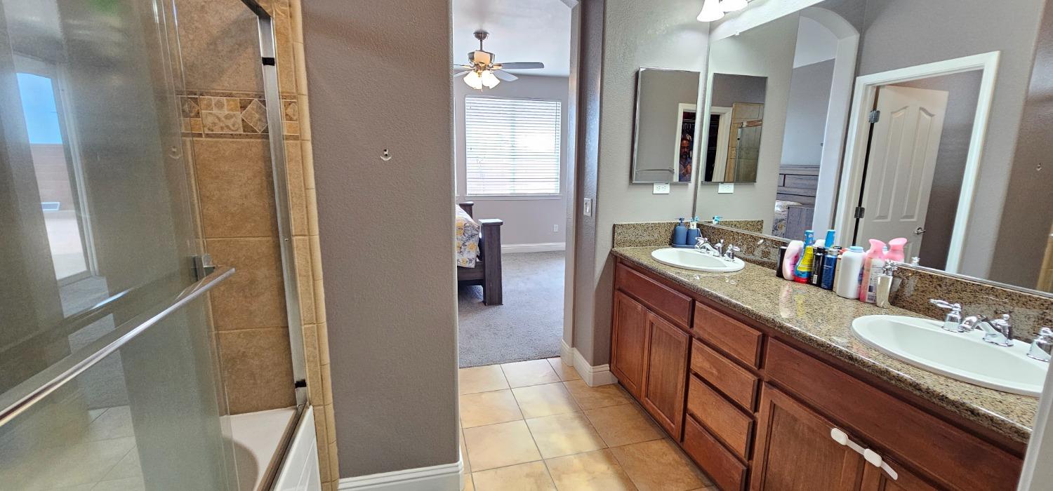 11724 Brook Valley Way Rancho Cordova, CA 95742 - Photo 29 of 32 a bathroom with a double vanity sink and mirror