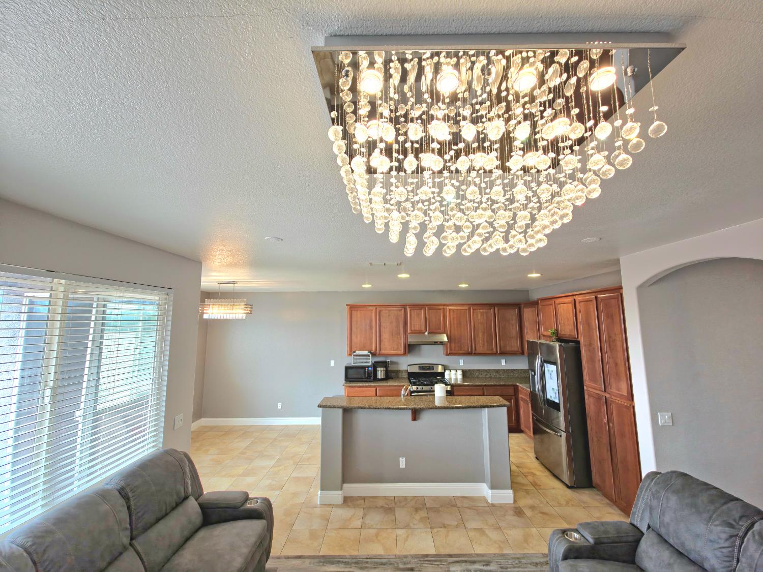 11724 Brook Valley Way Rancho Cordova, CA 95742 - Photo 6 of 32 a kitchen with a refrigerator and a couch