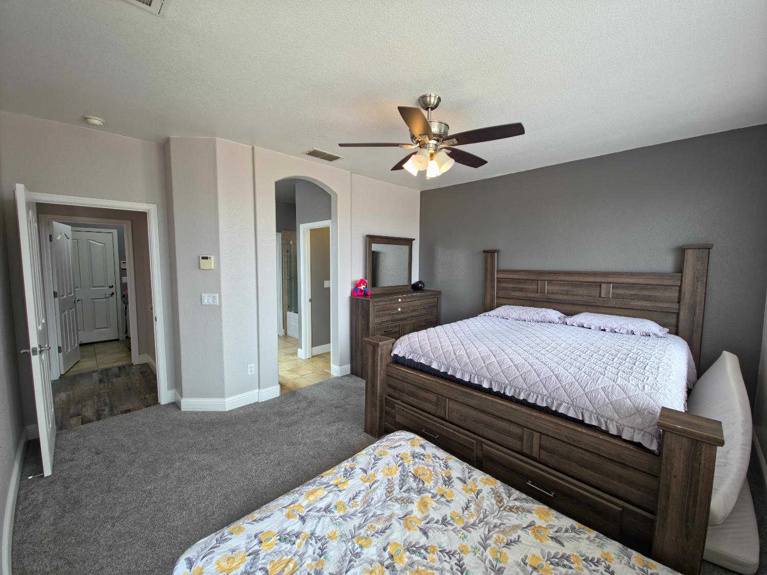 11724 Brook Valley Way Rancho Cordova, CA 95742 - Photo 8 of 32 a bedroom with a bed and a chandelier
