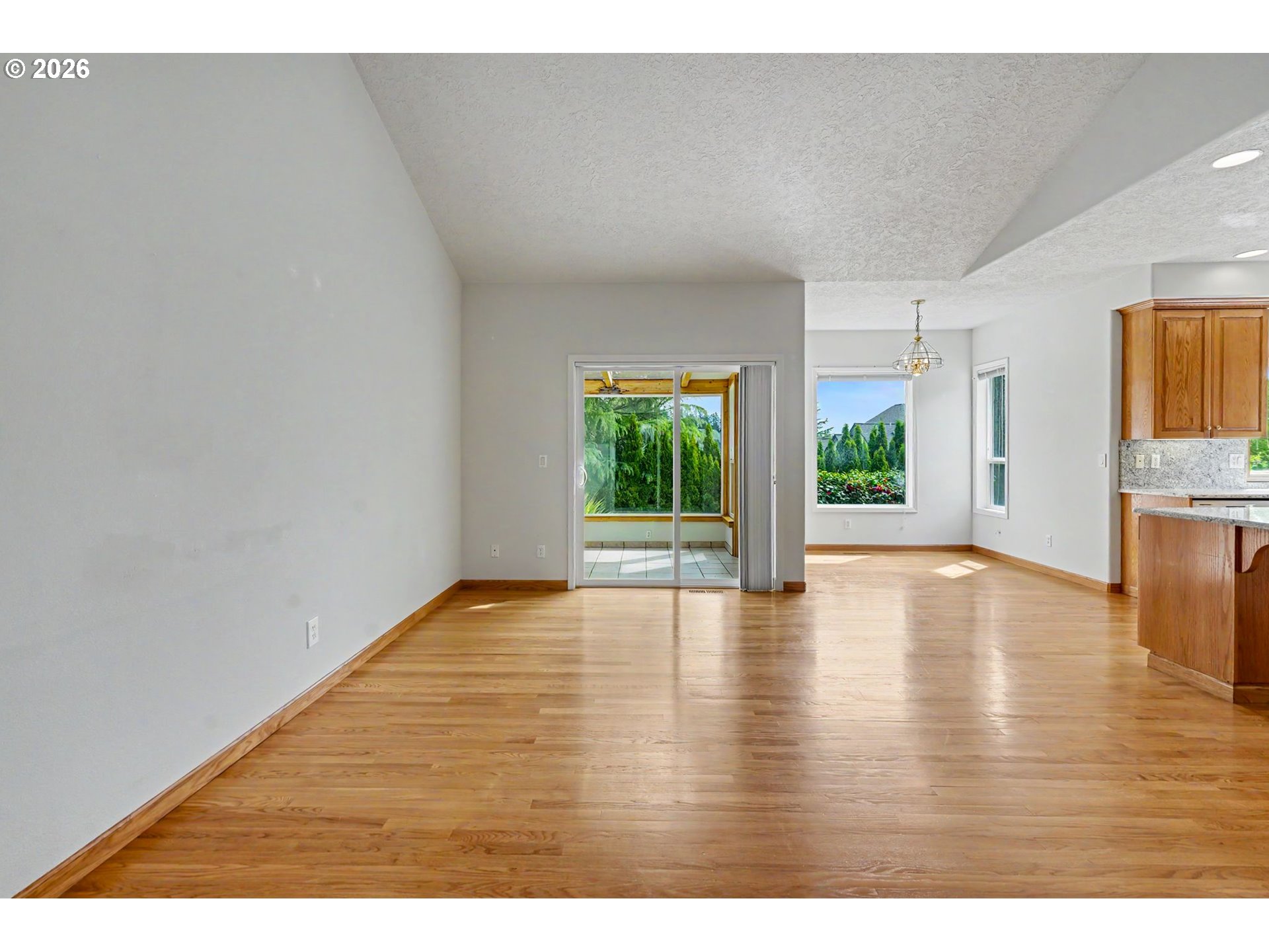 1470 Ranier Loop Northwest Salem, OR 97304 - Photo 22 of 48 a view of an empty room with wooden floor and a window