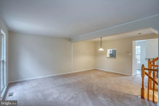 an empty room with windows and entrance