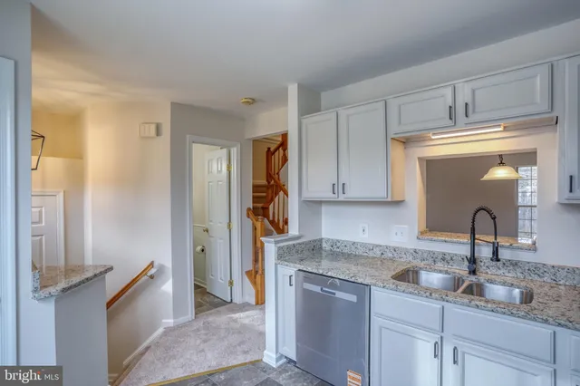 a kitchen with a sink and cabinets