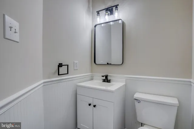 a bathroom with a toilet sink and mirror