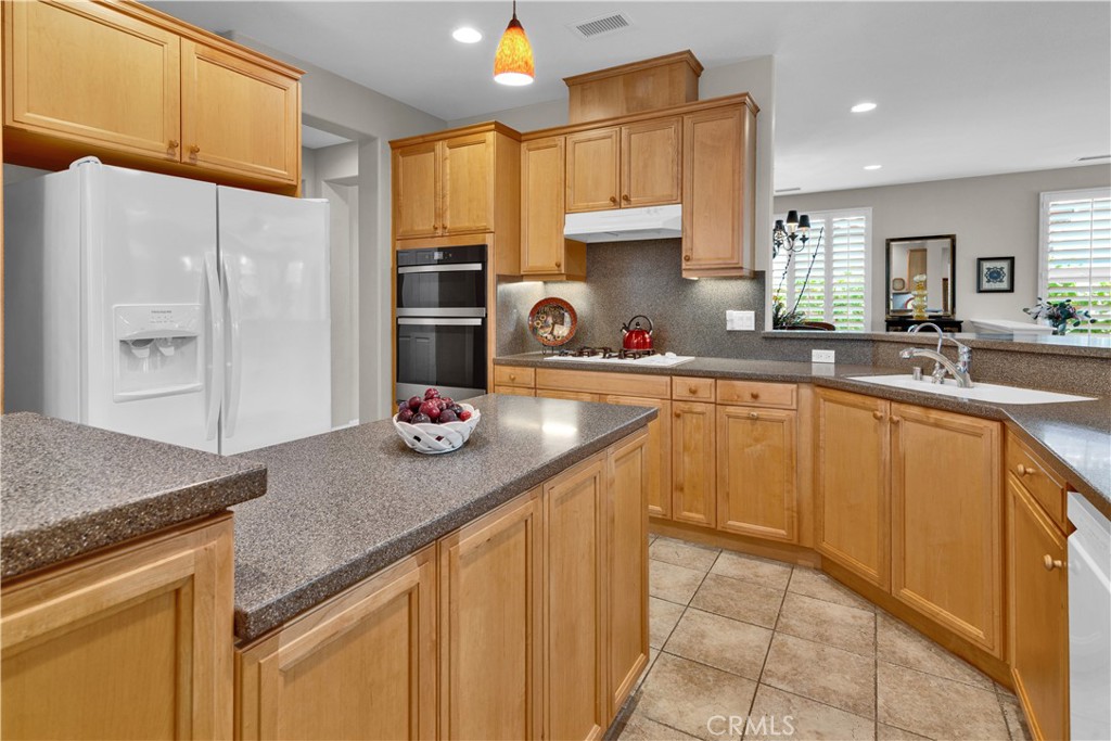 2757 Traditions Loop Paso Robles, CA 93446 - Photo 15 of 58 a kitchen with a sink refrigerator and cabinets
