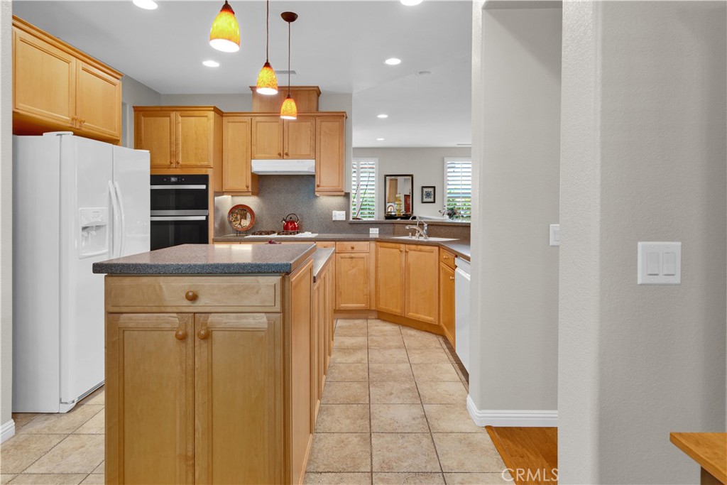 2757 Traditions Loop Paso Robles, CA 93446 - Photo 16 of 58 a kitchen with a sink a refrigerator and cabinets