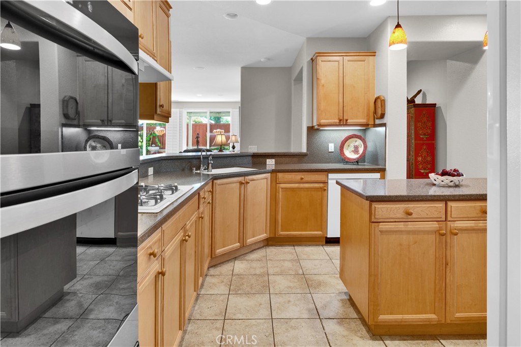 2757 Traditions Loop Paso Robles, CA 93446 - Photo 18 of 58 a kitchen with stainless steel appliances granite countertop a sink and cabinets