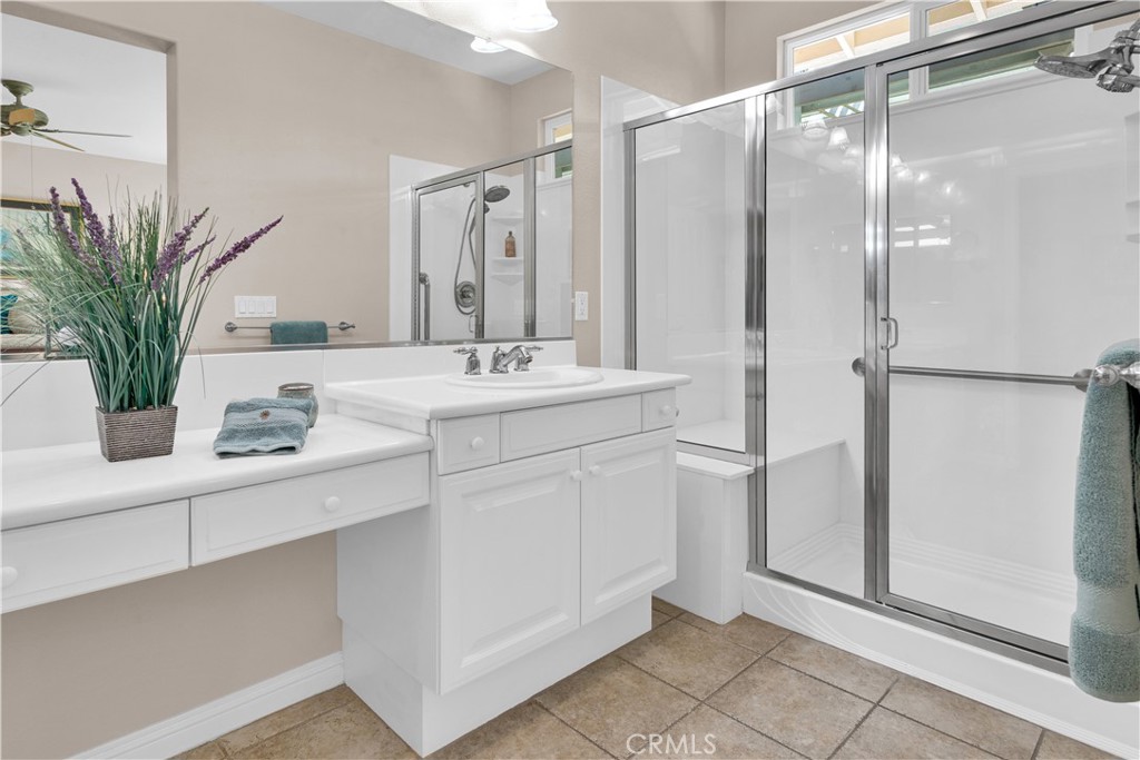 2757 Traditions Loop Paso Robles, CA 93446 - Photo 31 of 58 a bathroom with a shower sink vanity and a mirror