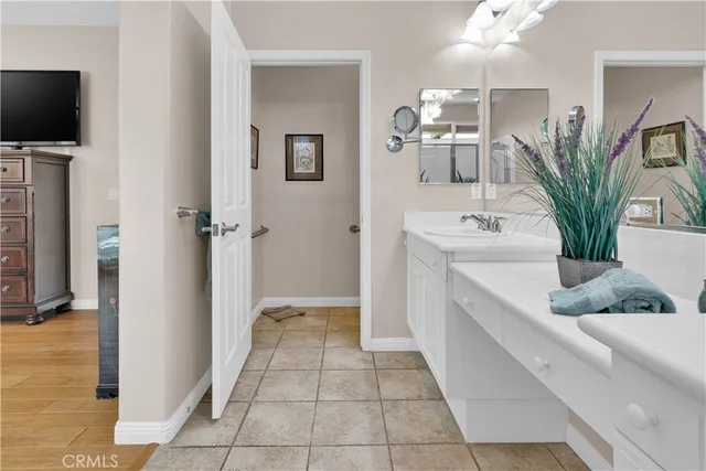 a bathroom with a shower a sink and a mirror