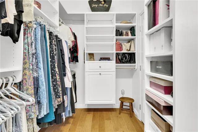 a view of walk in closet with clothes