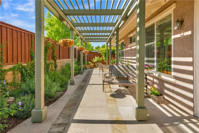 a view of a porch with a table and chairs