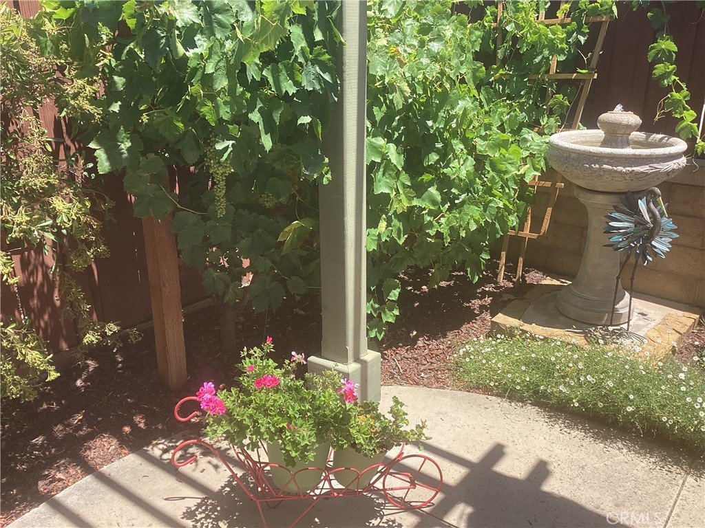 2757 Traditions Loop Paso Robles, CA 93446 - Photo 41 of 58 a front view of a house with a yard and fountain